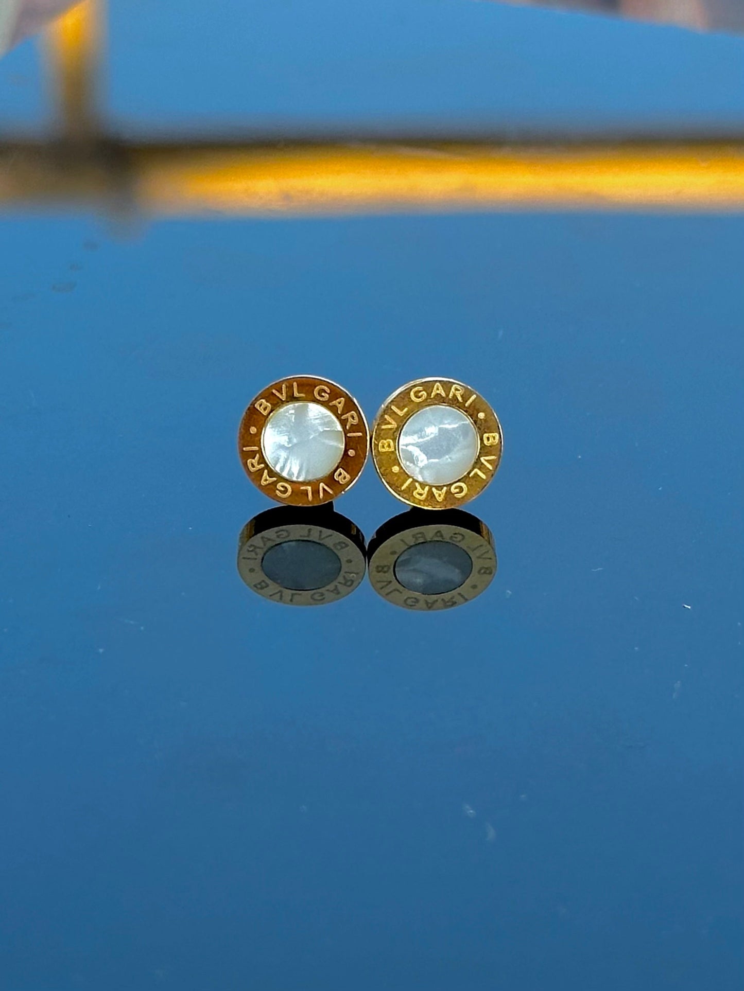 White Bvlgari engraved studs